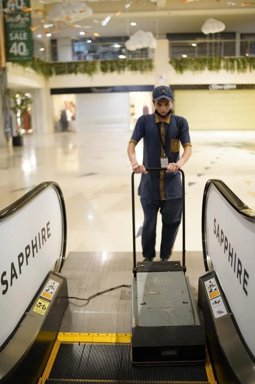 Technician maintaining an escalator at Sapphire, Dolmen Mall